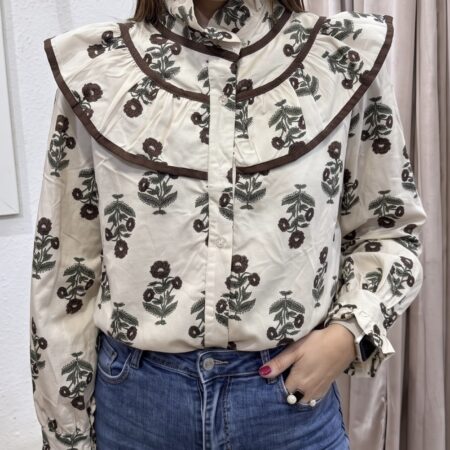 Blusa de manga larga tono crudo con estampado de flores silvestres en verde y marrón, con cuello grande de volante y ribete marrón en contraste.